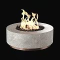 Round Gray Stone Fire Pit With Copper Base Black Pebbles And Burning Flames