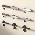 Door Handles In Modern Styles And Various Finishes Displayed On Beige Wall