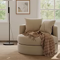 Wooden Side Table Next to Beige Armchair with Cup in Living Room Featuring Orange Sofa