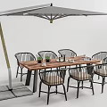 Wooden Top Outdoor Table with Woven Metal Frame Chairs and Gray Umbrella