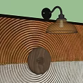 Wall Lamp With Black Arm Transparent Glass Shade On Brown White Concentric Circle Decorative Panel