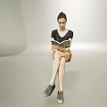 Woman Sitting Reading Book In Light Background Wearing Black Top Orange Shorts And Gray Shoes