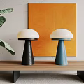 Stylish Table Lamps With White Shades Black Blue Bases On Wooden Table Orange Painting Green Leaves