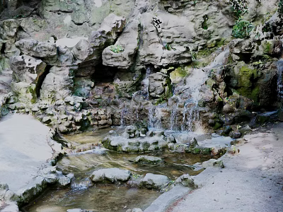 Tranquil Garden Landscape Featuring Rock Formations Small Waterfall Flowing Stream And Green Plants 3d model