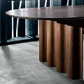 Modern Wooden Round Table With Unique Fluted Legs In Interior Setting