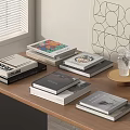 Stacks of Various Books on Wooden Table with Window Shutters and Geometric Wall Art