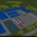 Industrial Factory with Blue Roof Cylindrical Tanks and Surrounding Trees