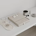 Decorative Ornament Set Featuring Beige Box Black Jar Small Bottle Glass Cups On Stone Tray