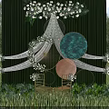 Outdoor Wedding Decor Setup With Green Backdrop White Flowers Circular Elements And Golden Chairs