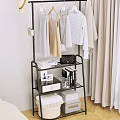 Stylish Multi Tiered Clothing Rack With Hanging Clothes Black Handbag Books And Photo Frame