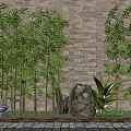 Tall Bamboo Plants Growing Against Stone Wall With Stone Sculptures And Garden Greenery