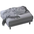 Gray Plaid Fabric And Black Leather Ottoman With Wooden Legs And Draped Black Blanket