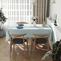 Bright Sunlit Minimalist Dining Room With Natural Wood Chairs And Soft Light Blue Tablecloth