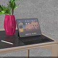 Tablet With Keyboard On Wooden Table Near Red Vase Green Plant And Stylus Pen