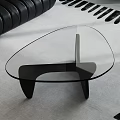 Stylish Glass Coffee Table With Unique Shape And Black Metal Legs For Modern Living Room