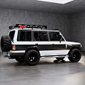 White and Black Off Road Vehicle With Roof Rack and Large Tires in Indoor Setting