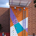 Outdoor Climbing Wall With Colorful Holds Ladder And Geometric Patterns On Brick Building