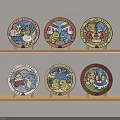 Set Of Colorful Decorative Plates With Cartoon Characters On Wooden Shelves