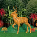 Check-in Photo Spot Featuring Large Woven Deer Sculpture Green Wavy Backdrop And Colorful Palm Leaves