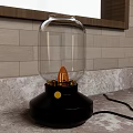 Table Lamp With Glass Shade Black Base Yellow Knob And Orange Bulb On Marble Countertop