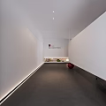 Modern Office Corridor With White Walls Gray Floor Red Sphere Green Plants And Recessed Lighting