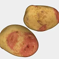 Two Fresh Yellow Potatoes with Red Spots on White Background