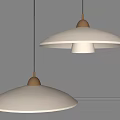 Modern Pendant Lights With White Shades And Brass Accents Illuminated Against Gray Wall