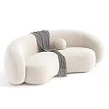 Curved Beige And Brown Sofa With Gray Throw Blanket And Round Pillow