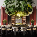 Elegant Private Dining Room With Hanging Floral Chandelier Round Table Red Walls And Potted Plants