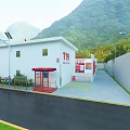 Industrial Factory With Red And White Exterior In Mountainous Green Landscape