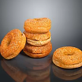Golden Brown Sesame Seed Bagels Stacked and Single on Black Surface
