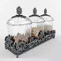 Three Glass Spice Jars with Decorative Lids on Ornate Metal Stand Containing Dried Spices