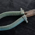 Old Green Handle Hardware Pliers With Rusty Metal Jaws On Black Surface