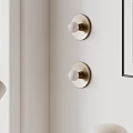 Modern Gold Wall Sconces with White Globe Shades in Minimalist Interior Design