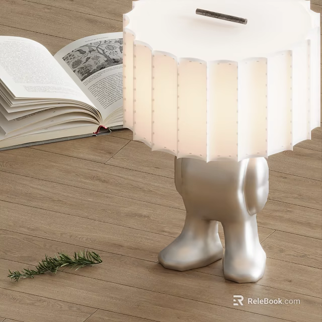 Table Lamp With White Pleated Lampshade Silver Humanoid Base And Open Book On Wooden Floor 3d model 