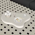 Stylish White Irregular Coffee Table With Checkered Basket Pink Glass Donuts And Golden Spoon