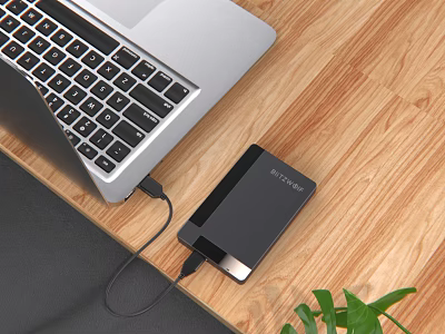 Silver Laptop Connected To Anker Power Bank On Wooden Desk With Green Plant 3d model