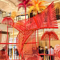 Vibrant Mall Photo Spot With Colorful Art Installation And Palm Like Structures