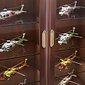 Dark Wooden Display Cabinets with Glass Doors and Shelves Holding Model Aircraft