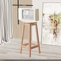 Vintage TV on Wooden Stool in Living Room with Abstract Painting Green Plant and Curtain