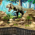 Reptile Exhibition Featuring Tyrannosaurus Rex Models In Jungle Environment With Rocks And Plants