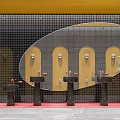 Modern Public Restroom with Yellow Walls Black Sinks Round Mirrors Glass Partitions and Plants