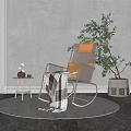 Cozy Woven Rocking Chair With Orange Cushion And Blanket Near Small Wooden Table Green Plant Gray Wall
