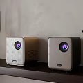 Sleek Modern Projectors Placed On Wooden Shelf With Wall Background And Plant