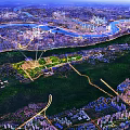 Aerial View of Urban Architecture Complex Along River With Green Spaces And City Roads
