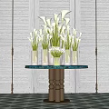 White Calla Lilies in Transparent Vases on Round Blue Glass Table with Metal Base