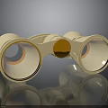 Gold Binoculars With Two Lenses Central Knob On Black Reflective Surface