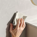 Hand Wiping Textured Gray Wall With Soft Light Colored Cloth