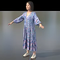 Woman In Blue Purple Floral Long Sleeve Dress Standing With Arms Outstretched On Gray Background