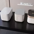 Modern Kitchen Appliances Three Rice Cookers With Different Designs On Black Countertop Minotli
